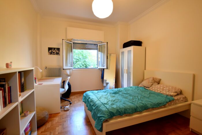 Bedroom with new flooring and aluminum window frame