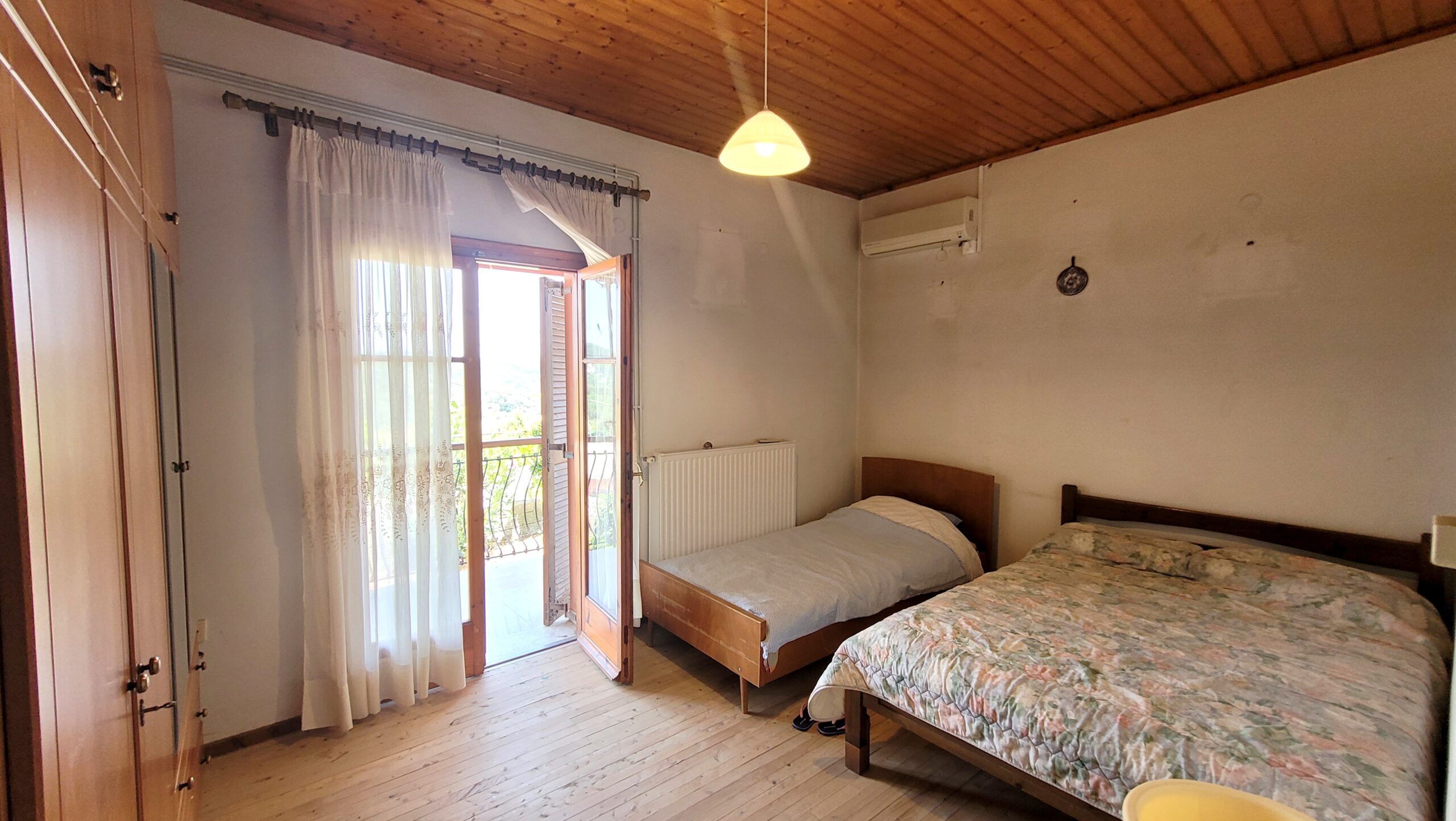 Bright bedroom with countryside view in Pagi house