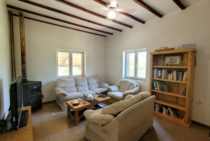 Living room with wood burner stove in Corfu home