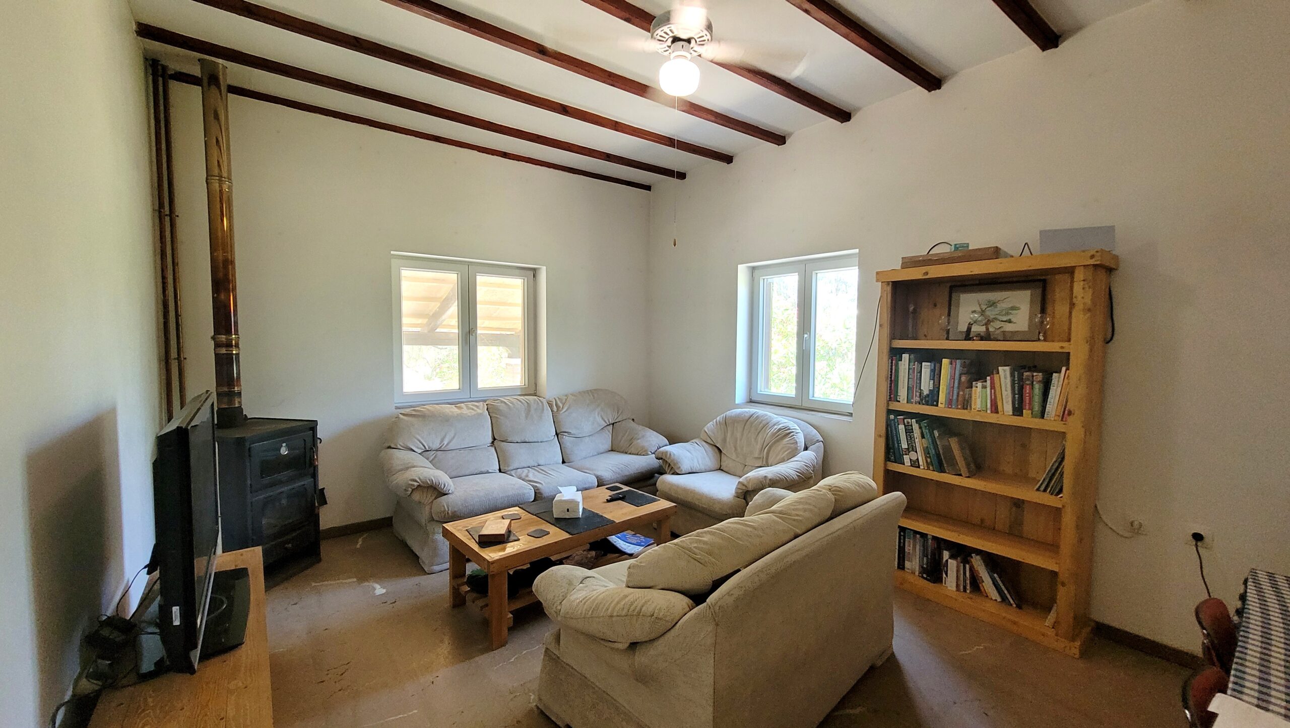 Living room with wood burner stove in Corfu home