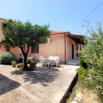 Paved courtyard with seating area between two detached houses in Pagi, Corfu