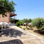 Lush garden with flowers and mature trees in Corfiot property