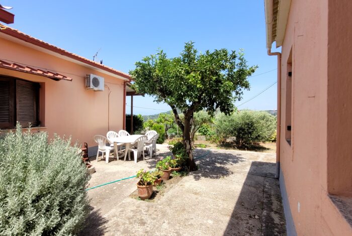 Spacious paved courtyard between two houses in Pagi