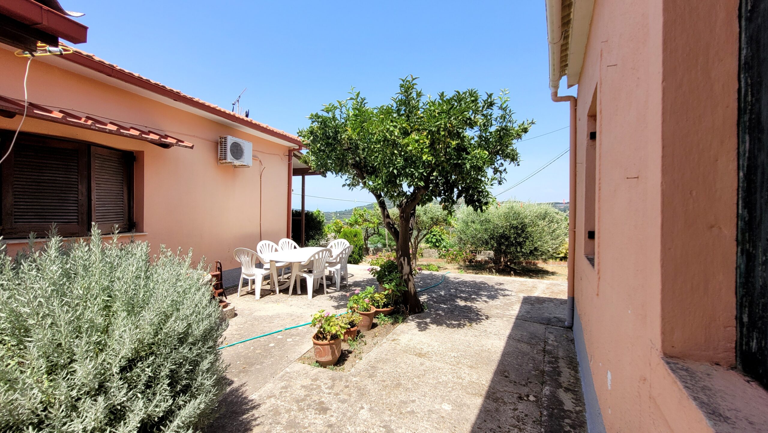 Spacious paved courtyard between two houses in Pagi