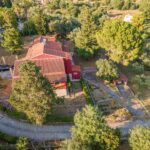 Aerial photo of the villa surrounded by mature trees