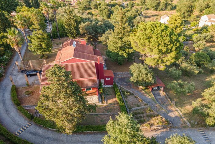 Aerial photo of the villa surrounded by mature trees