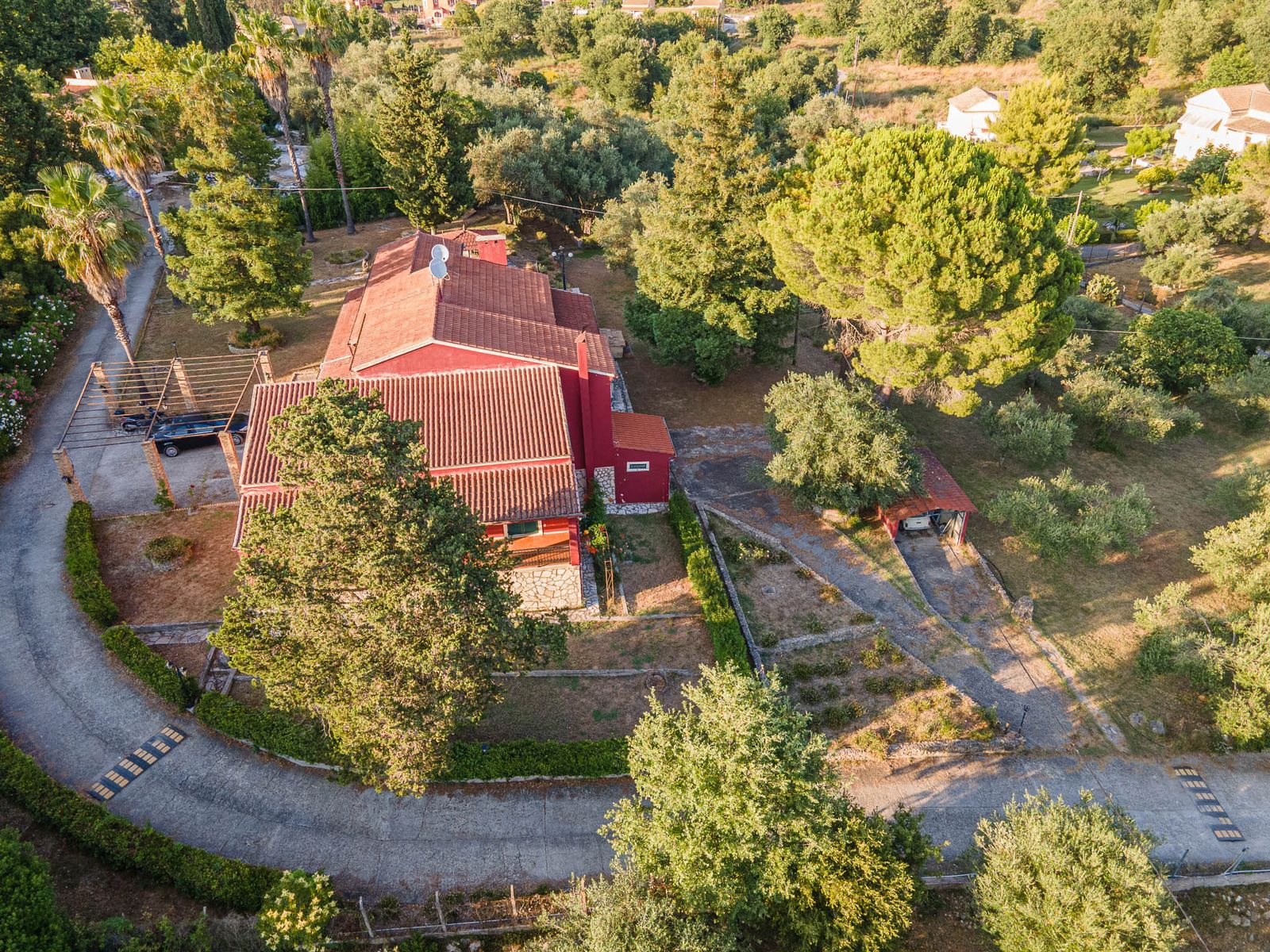 Aerial photo of the villa surrounded by mature trees