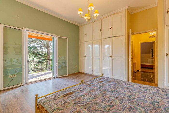 Master bedroom with large window and garden view