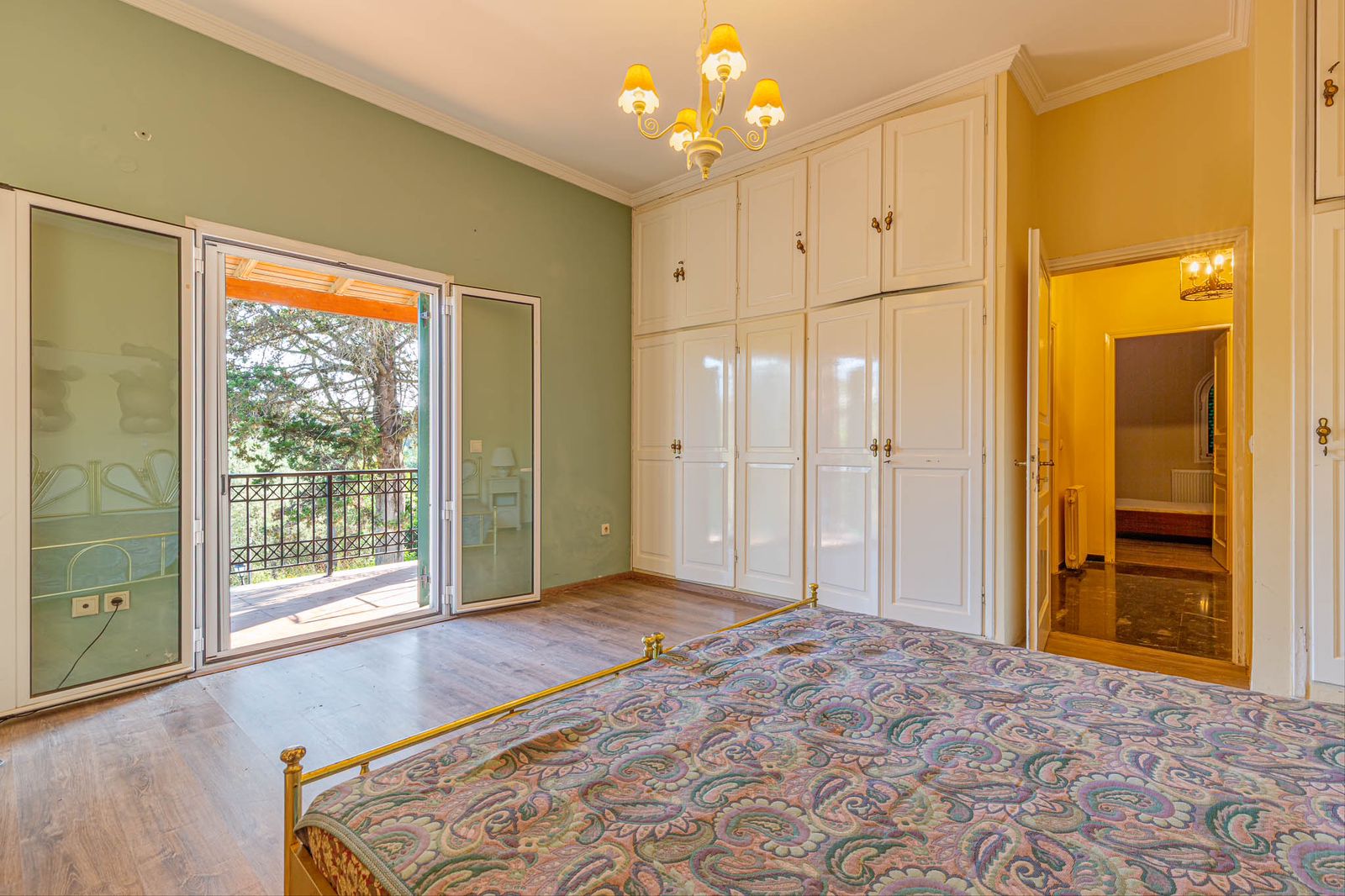Master bedroom with large window and garden view