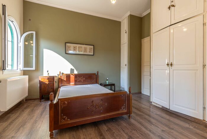 Airy bedroom with high ceiling and neutral decor