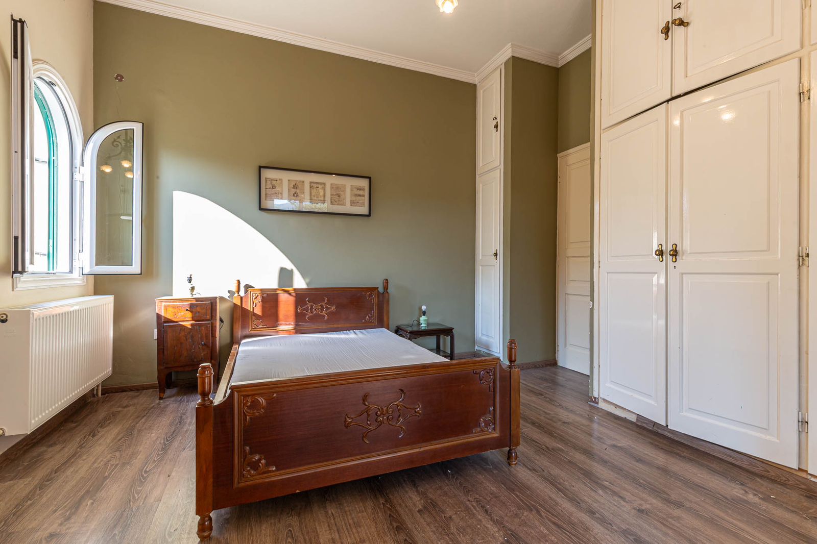 Airy bedroom with high ceiling and neutral decor