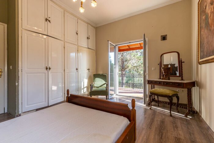 Spacious bedroom with tiled floor and built-in wardrobe