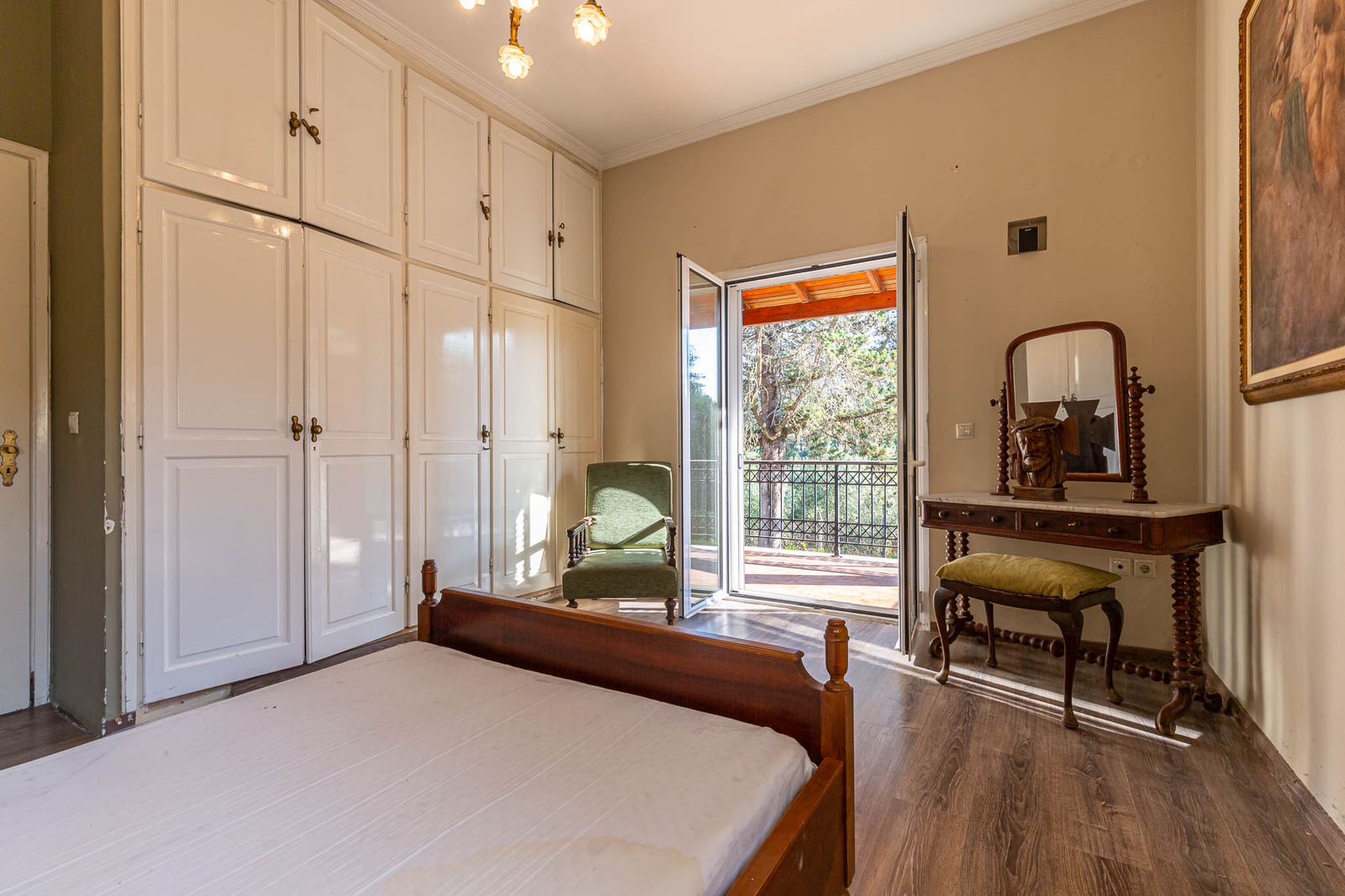 Spacious bedroom with tiled floor and built-in wardrobe