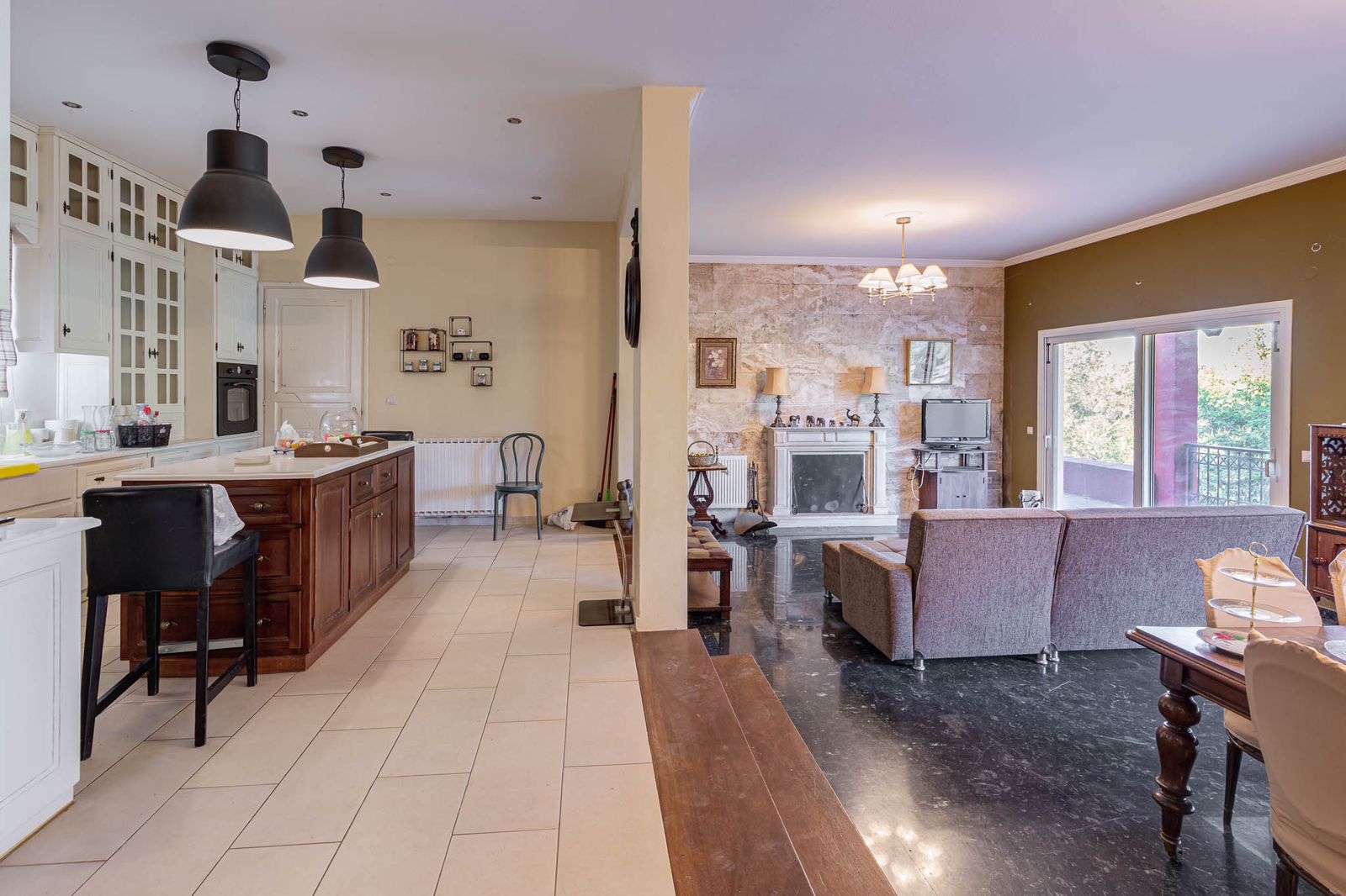 Living space with large windows and access to outdoor veranda