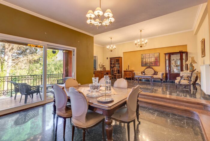 Spacious living room with comfortable seating and access to the veranda