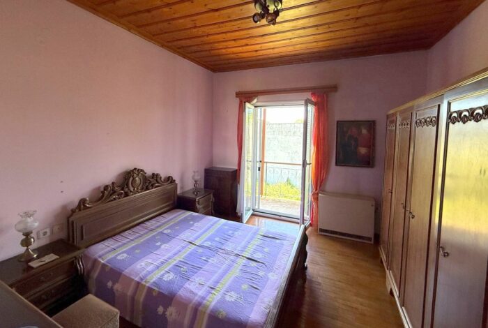 Bedroom with balcony doors in Perama detached house