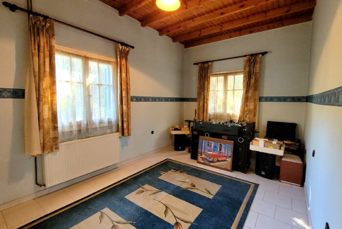 Bright bedroom with large window in countryside house in Corfu
