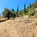 Plot surrounded by lush landscape in Doukades