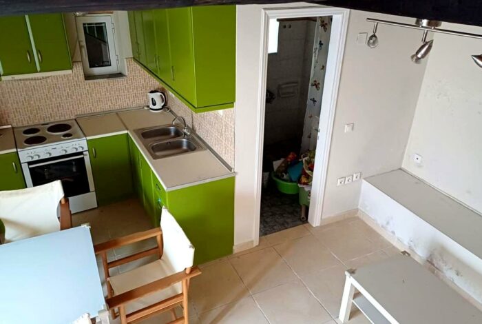 Ground floor area with an open plan kitchen/living room and the bathroom