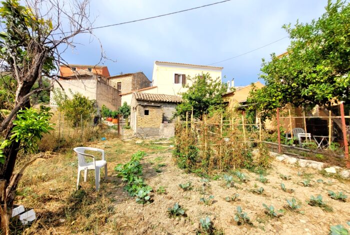 Flat buildable plot next to stone house for sale