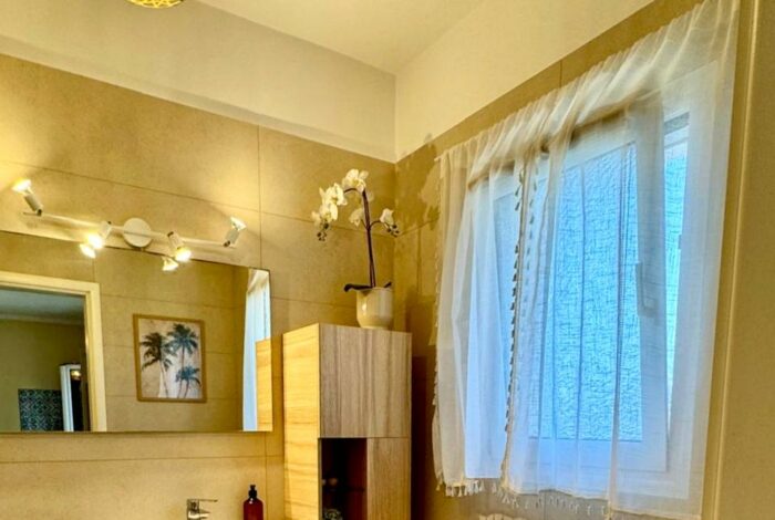 Ground floor bathroom with sleek fixtures and bright tones