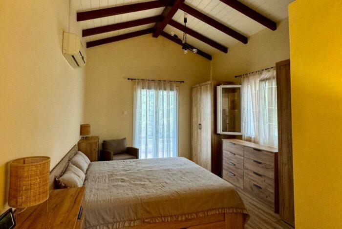 Spacious master bedroom with large windows and ensuite bathroom