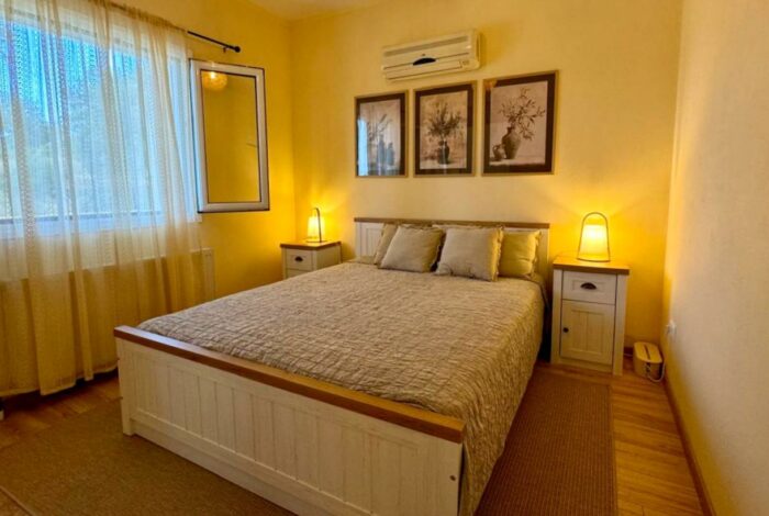 Furnished bedroom with double bed and storage furniture