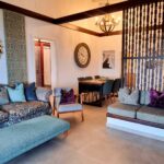 Open plan living room with fireplace and views to the sea