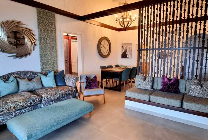 Open plan living room with fireplace and views to the sea