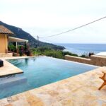 Saltwater swimming pool with sun terrace and sea views in Corfu villa