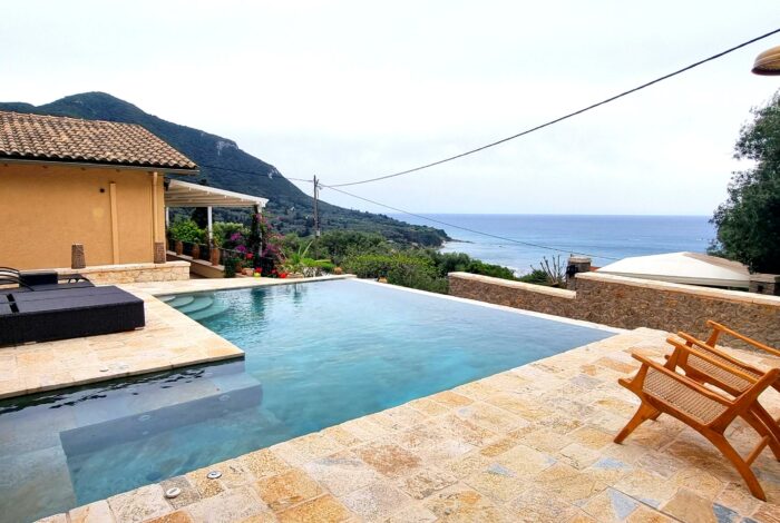 Saltwater swimming pool with sun terrace and sea views in Corfu villa