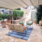 Outdoor seating area with gardens and sea view in Corfu villa