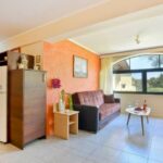 Open-plan living room with kitchen in Corfu apartment