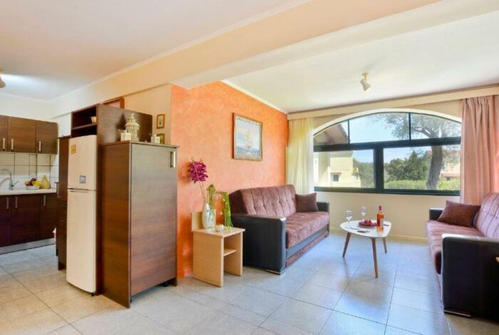 Open-plan living room with kitchen in Corfu apartment