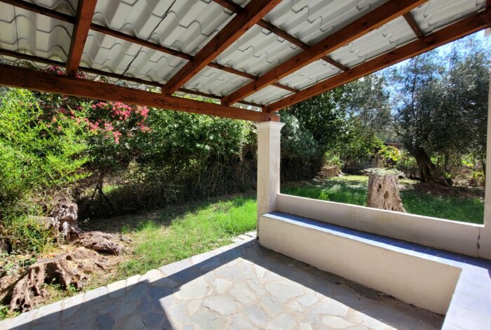 Garden and covered patio area of maisonette for sale in Corfu