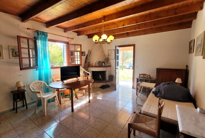 Living room with fireplace in maisonette Agios Georgios South Corfu property for sale