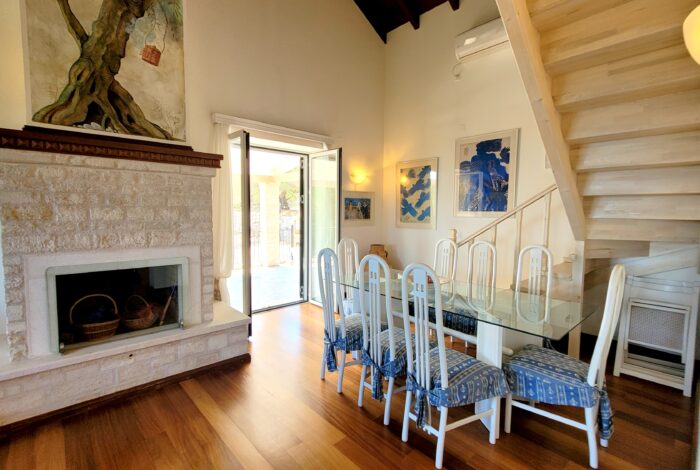 Open-plan lounge and dining room with terrace access Paxos villa for sale
