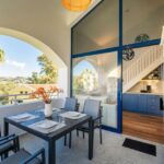 Outdoor breakfast and dining space at the balcony overlooking the garden and swimming pool