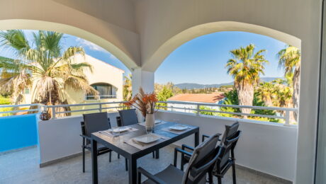 Large private veranda overlooking landscaped gardens in Corfu resort apartment