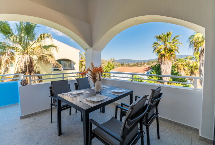 Large private veranda overlooking landscaped gardens in Corfu resort apartment