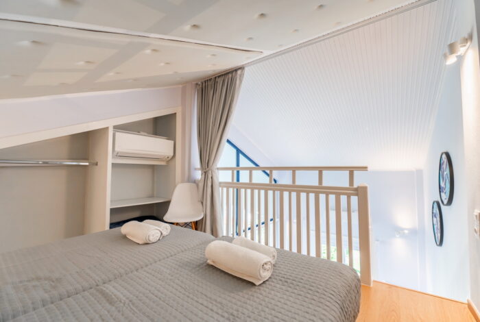 Cozy attic-style mezzanine bedroom in Corfu apartment for sale