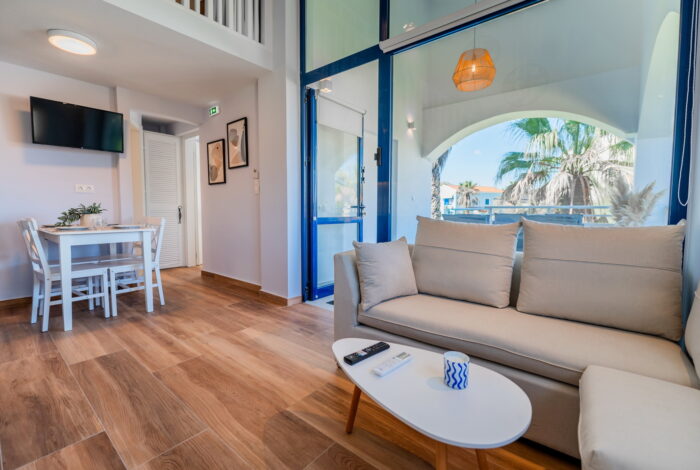 Spacious living room with modern furnishings in Corfu apartment for sale