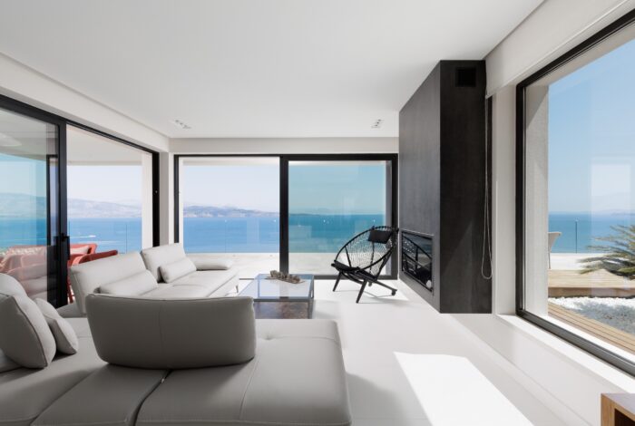 Spacious open-plan living room with sea view windows