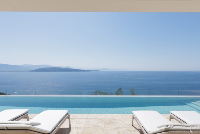 Outdoor swimming pool area with infinity sea view