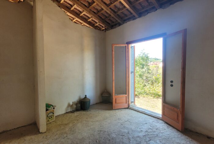 Bright bedroom space with renovation potential in Corfu home