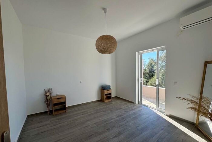 Comfortable bedroom space with wooden floors Corfu investment home