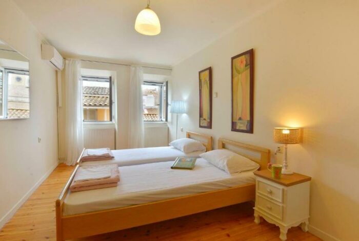 Bright bedroom with double bed and wooden flooring, Corfu old town
