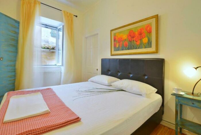 Cozy guest bedroom in renovated Corfu apartment for sale