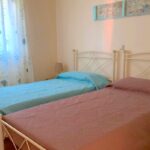 Cozy bedroom with large window and plenty of natural light – Kanalia Corfu apartment