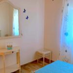 Bright bedroom with tiled floors and simple decor in Corfu property for sale